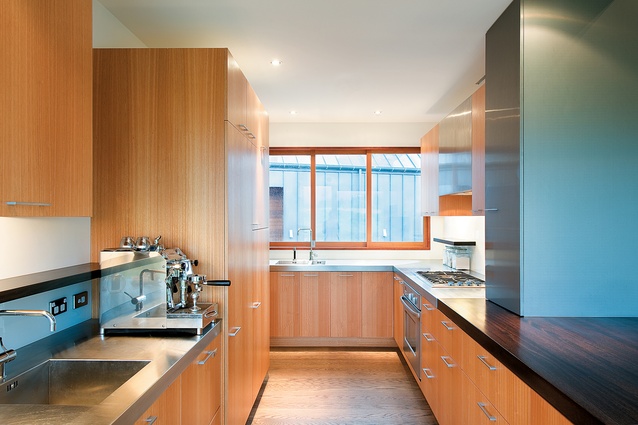 The kitchen makes use of the house’s signature materials: timber and zinc. 