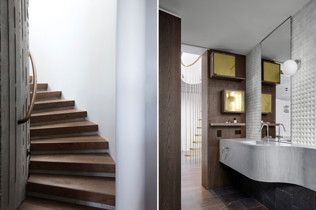 The elliptical stairwell has oak treads and rails; the bathroom features a curved concrete vanity and oak walls.