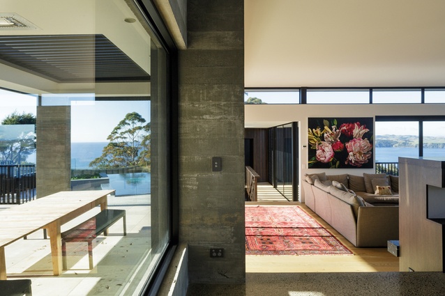 The landing space and its robust in-situ concrete columns serve to partially block views and lead the eye down to the living space.