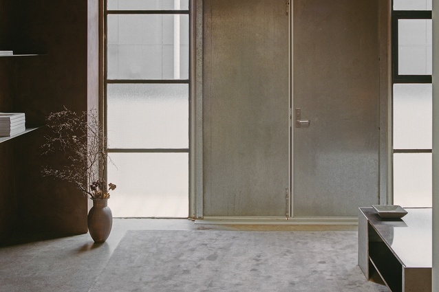 Galvinised steel with mineral coating seen on the doors and table in the entry way.