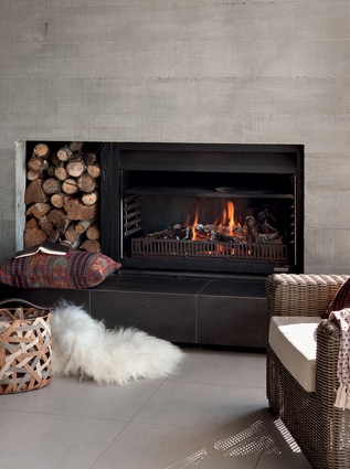 This concrete backed fireplace creates a cosy outdoor room.