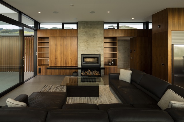 Matheson House, Nelson. The-open plan living area features warm walnut panelling.