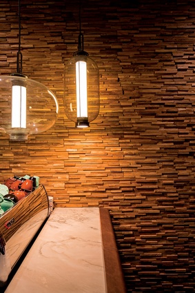 A timber feature wall divides the bar and reception area and makes the space softer and more intimate.