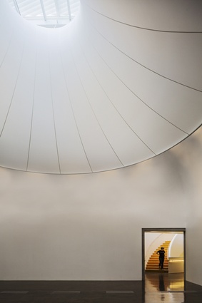 Light is diffused into high spaces with the use of a fabric lantern inside the main gallery of Te Uru Waitakere Contemporary Gallery, Titirangi.