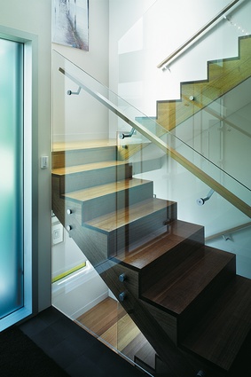 The glassed-in stair with the clashed-edge tread detail is an example of the considered use of both materials and form throughout the house.