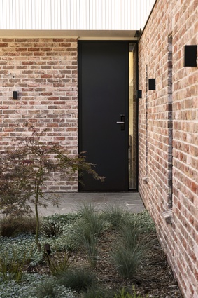 The homeowners requested a high stud height, exemplified here by a tall front door.