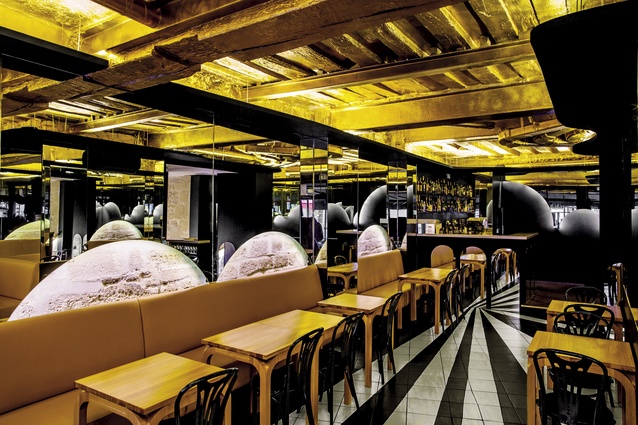 Designer José Levy wanted the restaurant to be eye-catching from the street – a raw ceiling covered with gold leaf achieves this desired effect.  