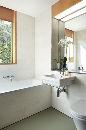 White finishes in the bathroom reflect the light, lending it bright, breezy appeal. 
