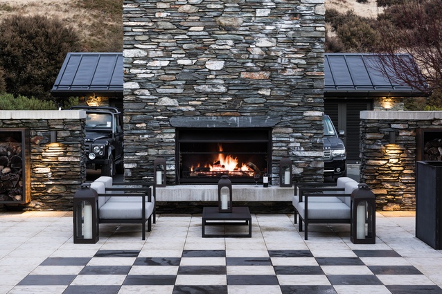 A sheltered courtyard with a fireplace provides an all-weather outdoor space.