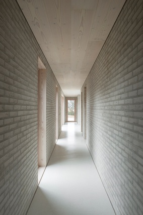 Pale white bricks complement whitewashed timber ceilings and white concrete floors.
