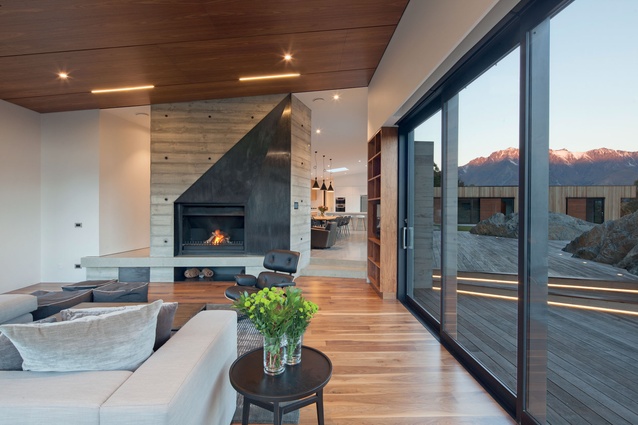 A feature concrete fireplace separates the otherwise open living area. 