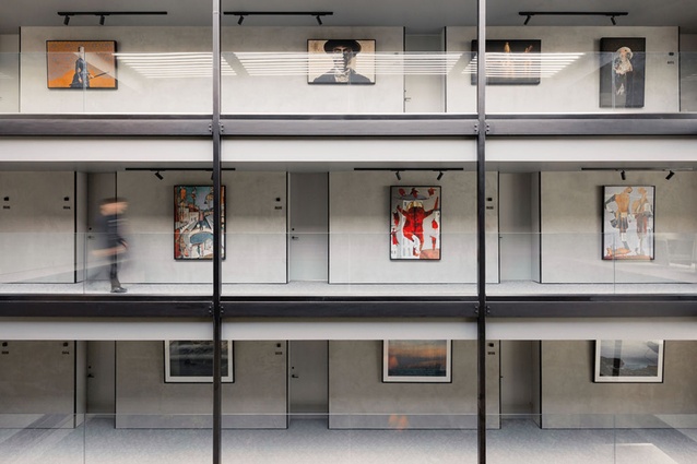 The upper-level walkways leading to guest rooms serve as gallery space. On level 2 are prints by landscape photographer Irenaeus Herok; works on levels 3 and 4 are by Ilya Volykhine and Sofia Minson.