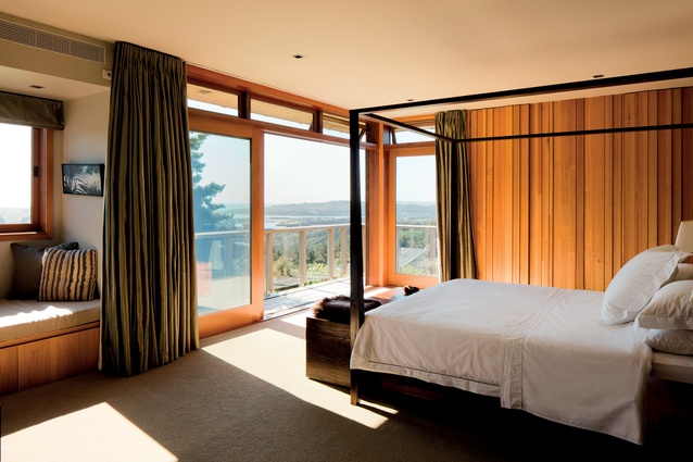 This bedroom has a panoramic rural view and opens onto a balcony.
