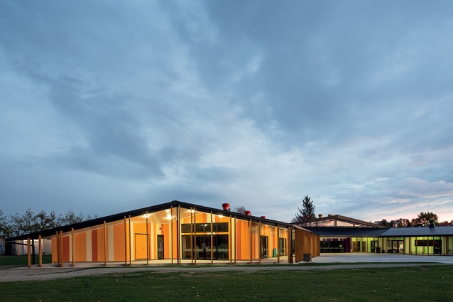 This is a modern and expressive school building. One arm is the wharekura, seen here, which is colour-coded in yellow and orange. 