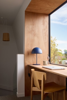 Upstairs, the landing acts as a home office.