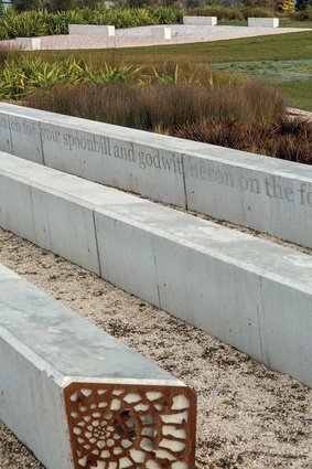 Concrete seating with perforated metal screens at ends. The bleachers are inscribed with a purpose-written poem by Cliff Fell.