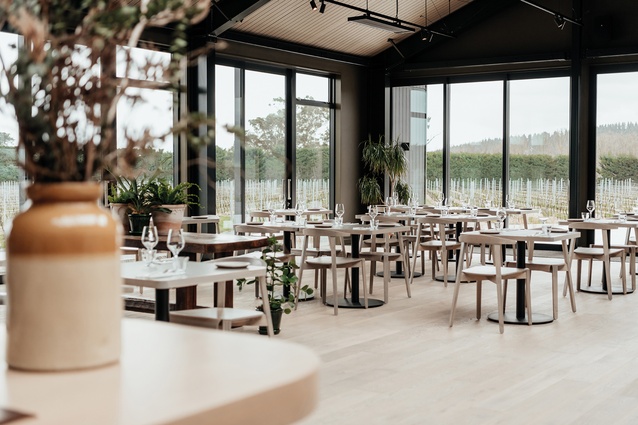 An openplan restaurant space opens to the outdoor terrace and vineyard.