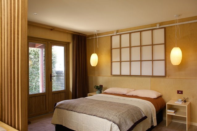 A shoji screen acts as movable headboard and focal feature. The screen also reflects light within the space and gives the illusion of a window.