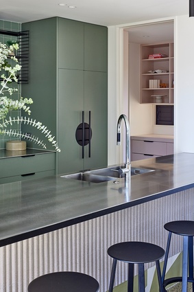 Looking across the plate steel island bench  towards the scullery and laundry space.