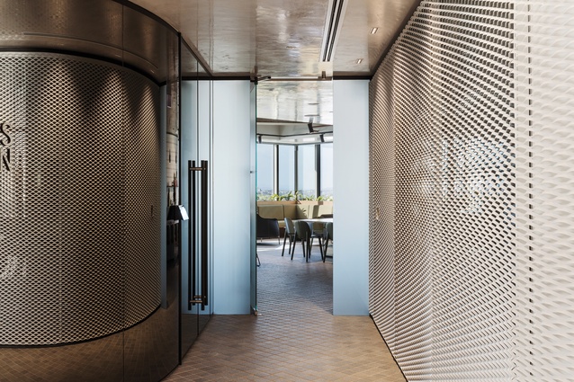 Through a tall, heavy door, the arrival area transitions to the central amenities space.