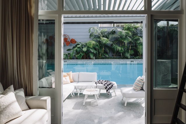 A serene view out from the living area to the outdoor pool.