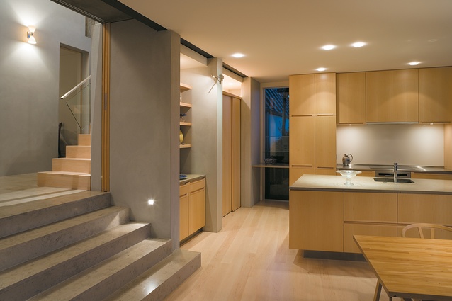 Steps from the entry/circulation area lead down into a large, rectangular north-facing pavilion holding the kitchen and living spaces; joinery thoughout is beautifully crafted.