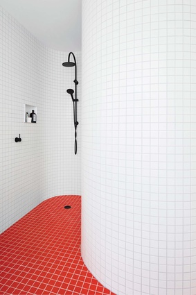 Sinuous walls in the upstairs bathrooms create private pockets for bathing.