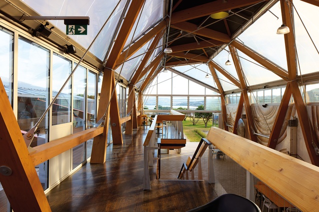 An upper floor of timber has been delicately slid into the upper floor of the five-sided, multi-triangulated structure.