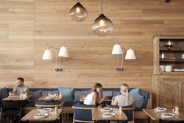 The wall on American white oak offers a light, Scandinavian feel to this seating area of the eatery. 