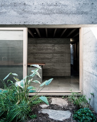 The kitchen looks onto the narrow length of garden that extends from the central courtyard.