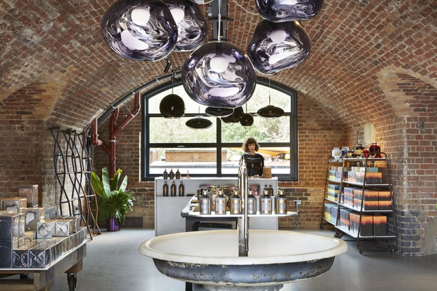 Smoke and copper Melt pendants are clustered throughout the retail area, showroom and workspaces.