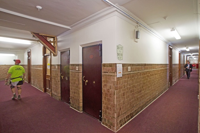 The original mottled-brown wall tiling, dark wood and narrow corridors in the floors above are still fully functional. 