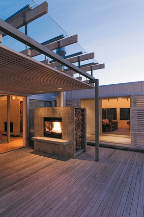 Looking back across the courtyard from the bedrooms to the outdoor fireplace and covered deck.