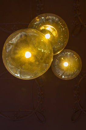 Hand-blown amber glass pendants by Luke Jacomb. 
