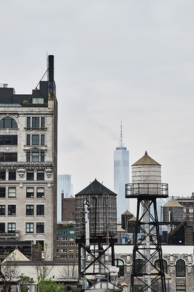 Water towers, seen from the roof of the building, dot the Manhattan skyline.