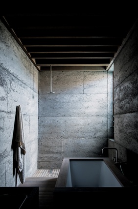 Rammed concrete absorbs light and brings a soft yet textured quality to the walls.