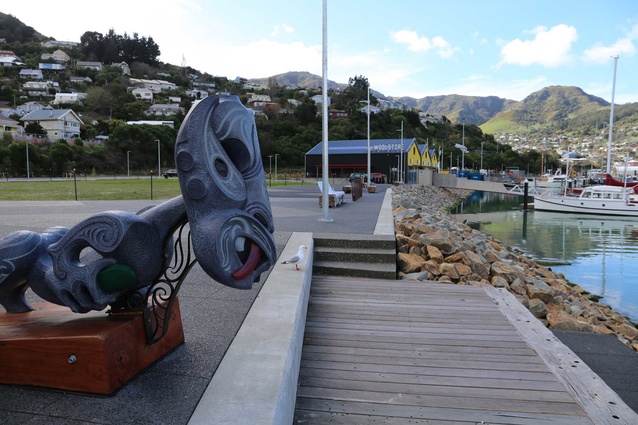 The tauihu sculpture created by Whakaraupo Carving overlooks the terrace of milled reclaimed wharf piles and out toward Lyttelton Harbour.