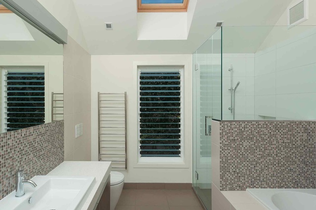 The family bathroom has private views through to the trees of a neighbouring orchard. 