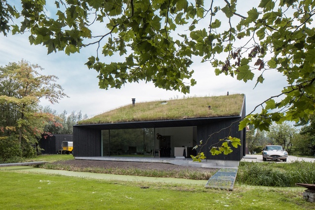 VillaSG21, Netherlands, by FillieVerhoeven Architects. 2017. The sloping roof fits with the local vernacular architecture but is also a turf roof which seems to extend the garden.
