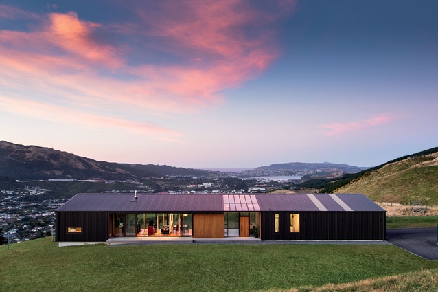 Designed to mitigate the buffering effects of the wind while maximising the views and solar gain, this house by architect Hugh Tennent presents as a simplifed single form.