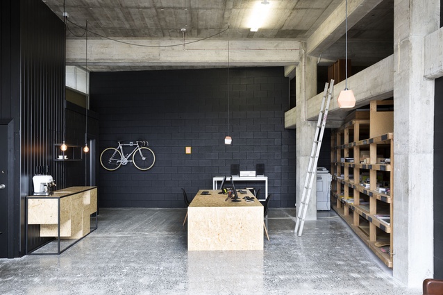 Red Architecture's new premises is a converted warehouse. Original storage racks have been retained. 