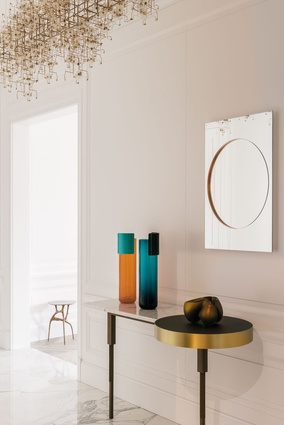 A Pierre Charpin mirror in the entry echoes the circular form in the Doshi Levien console.