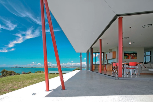 Floating terrace with chopstick columns create and frame transition between living area and Hauraki Gulf.
