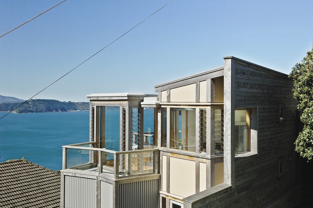 The Wedge House on its elevated site looking across Wellington harbour.