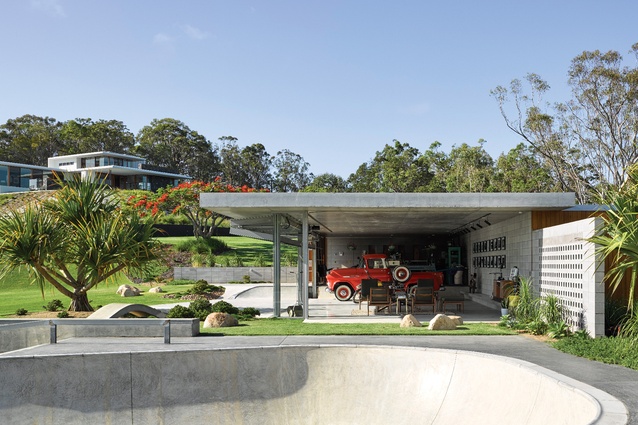 A secondary pavilion nestles into the hillside to accommodate a car collection and a workshop.