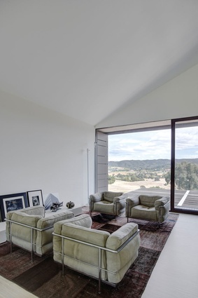 There are connections between the indoors and outdoors through the choice of furniture and the wide-spanning windows. 
