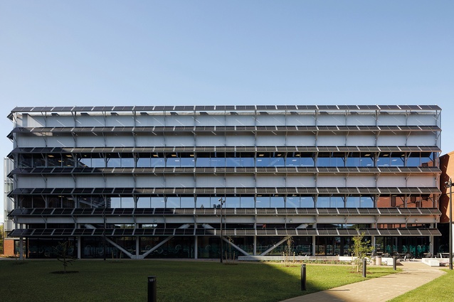 Photovoltaic panels act as a brise soleil on the northern elevation of the research volume.