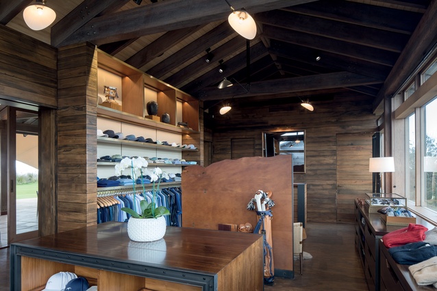 The pro shop features heavy industrial and dark timber display units.