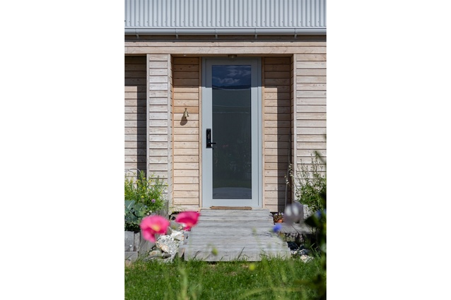 An heirloom bell hangs at the entranceway to the home. Doing away with the need for keys,
the front door features an electronic keypad.