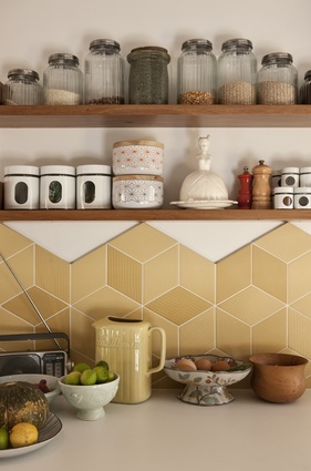 Retro mustard-coloured tiles enhance the kitchen space. 